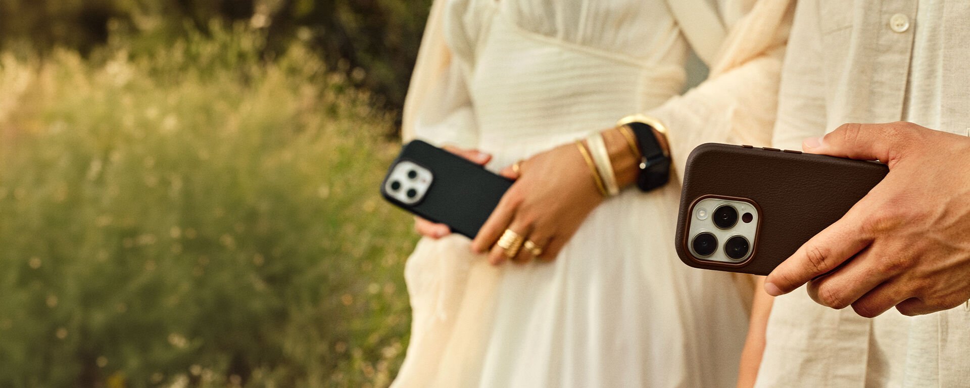 man and woman wearing white linen clothing and holding cactus leather iPhone cases